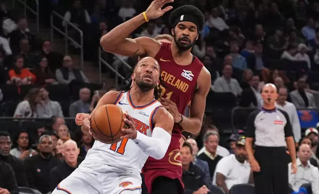 New York Knicks' Jalen Brunson (11) drives past Cleveland Cavaliers' Jarrett Allen (31) during the second half of an NBA basketball game Wednesday, Oct. 22, 2025, at Madison Square Garden in New York. (AP Photo/Frank Franklin II)