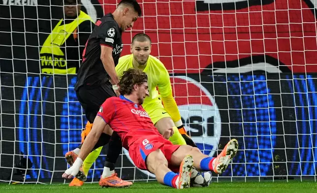 Leverkusen's Claudio Echeverri is fouled by PSG's Illya Zabarnyi during a Champions League opening phase soccer match between Bayer Leverkusen and Paris Saint-Germain in Leverkusen, Germany, Tuesday, Oct. 21, 2025. (AP Photo/Martin Meissner)