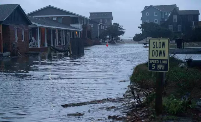 A road is inundated in the midst of a storm, Sunday, Oct. 12, 2025, in Buxton, N.C. (AP Photo/Allison Joyce)
