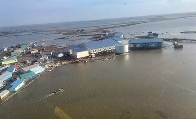 In this photo provided by the U.S. Coast Guard, Kipnuk, Alaska, experiences coastal flooding, Sunday, Oct. 12, 2025. (U.S. Coast Guard via AP)