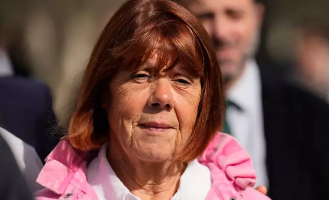 Gisele Pelicot leaves the courthouse for a break during the appeals trial in the case of a man challenging his conviction, less than a year after the landmark verdict in a drugging and rape trial that shook France Thursday, Oct. 9, 2025 in Nimes, southern France. (AP Photo/Lewis Joly)