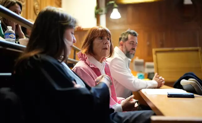 Gisele Pelicot, center, sits in the courtroom during the appeals trial in the case of a man challenging his conviction, less than a year after the landmark verdict in a drugging and rape trial that shook France Thursday, Oct. 9, 2025 in Nimes, southern France. (AP Photo/Lewis Joly)