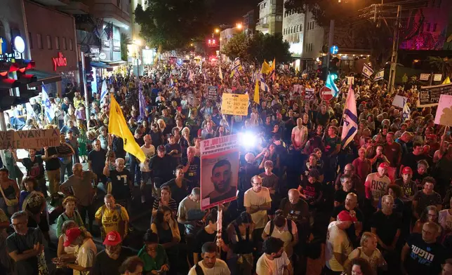 Demonstrators march in Tel Aviv, Israel, on Tuesday, Sept. 30, 2025, calling for the immediate release of all hostages held by Hamas in the Gaza Strip and an end to the ongoing war. (AP Photo/Ariel Schalit)