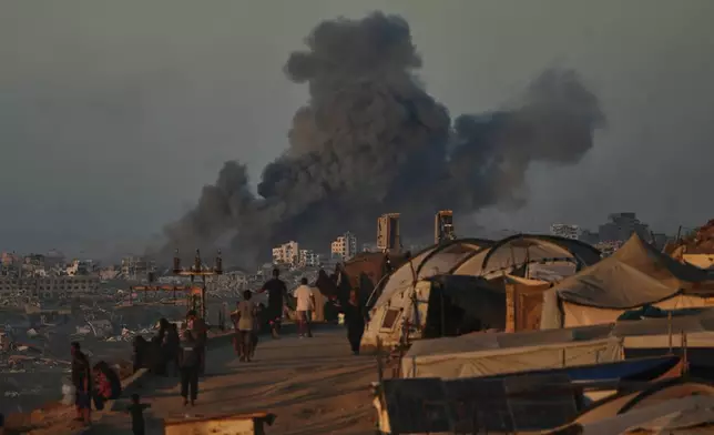 Smoke rises following an Israeli military strike in Gaza City, as seen from the central Gaza Strip, Wednesday, Oct, 1, 2025. (AP Photo/Abdel Kareem Hana)