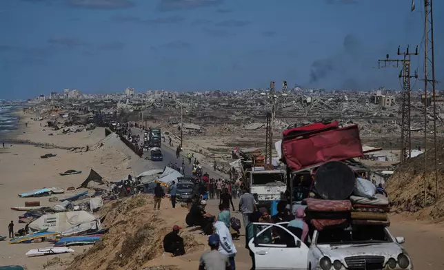 Displaced Palestinians flee northern Gaza carrying their belongings along the coastal road near Wadi Gaza, Wednesday, Oct, 1, 2025. (AP Photo/Abdel Kareem Hana)