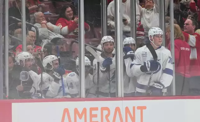 Tampa Bay Lightning players look from the penalty box during the second period of an NHL hockey preseason game against the Florida Panthers, Saturday, Oct. 4, 2025, in Sunrise, Fla. (AP Photo/Lynne Sladky)