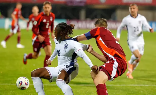 England's Eberechi Eze is pulled back by Latvia's Antonijs Cernomordijs during the 2026 World Cup group K qualifying soccer match between Latvia and England in Riga, Latvia, Tuesday, Oct. 14, 2025. (AP Photo/Mindaugas Kulbis)