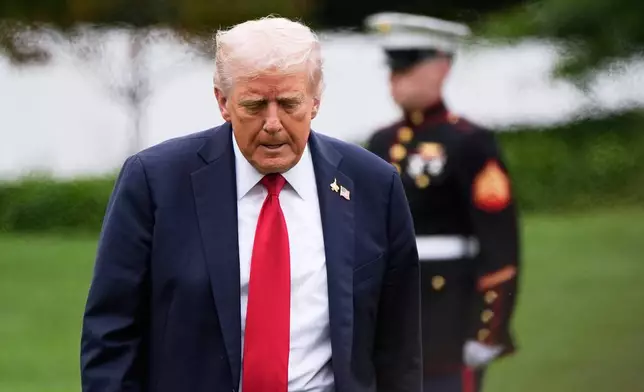 President Donald Trump walks from Marine One after arriving on the South Lawn of the White House, Tuesday, Sept. 30, 2025, in Washington. (AP Photo/Alex Brandon)