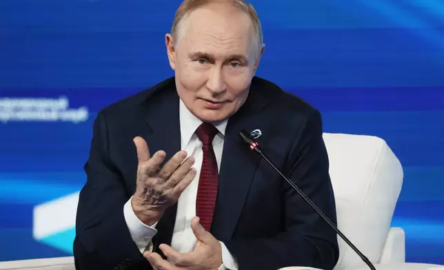 Russian President Vladimir Putin gestures as he answers questions during a meeting with foreign policy experts at the Valdai Discussion Club in the Black Sea resort of Sochi, Russia, on Thursday, Oct. 2, 2025. (Mikhail Metzel, Sputnik, Kremlin Pool Photo via AP)