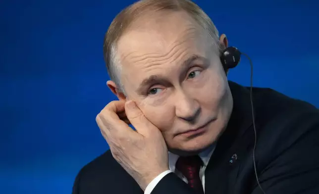 Russian President Vladimir Putin answers questions during a meeting with foreign policy experts at the Valdai Discussion Club in the Black Sea resort of Sochi, Russia, on Thursday, Oct. 2, 2025. (Grigory Sysoyev, Sputnik, Kremlin Pool Photo via AP)