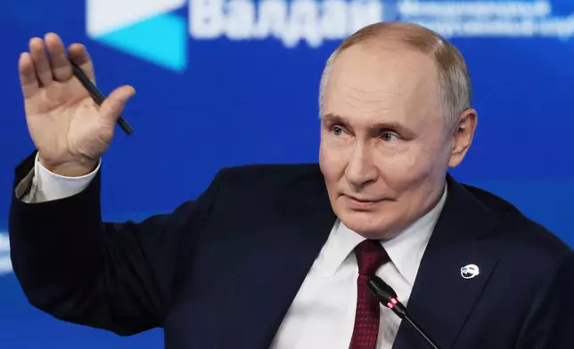 Russian President Vladimir Putin gestures as he answers questions during a meeting with foreign policy experts at the Valdai Discussion Club in the Black Sea resort of Sochi, Russia, on Thursday, Oct. 2, 2025. (Mikhail Metzel, Sputnik, Kremlin Pool Photo via AP)