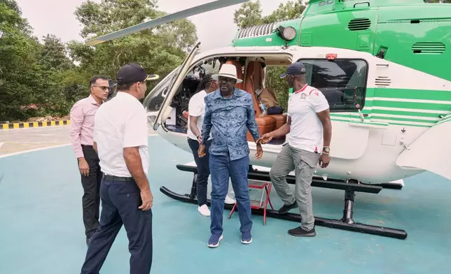 Former Kenyan Prime Minister Raila Odinga, center in blue, arrives at the Sreedhareeyam Ayurvedic hospital in Koothattukulam, Kerala, India, Friday, Oct.10, 2025. (AP Photo/Manu.K.S)