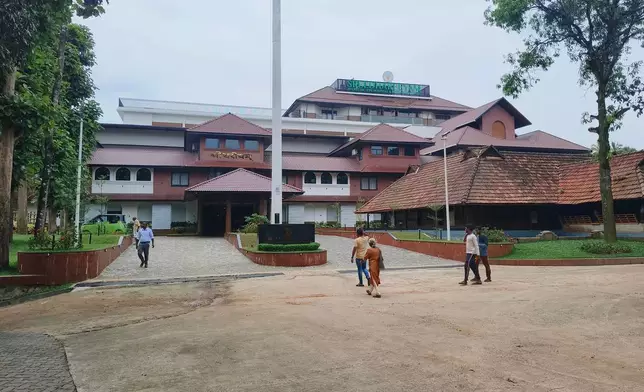 People walk outside the Sreedhareeyam Ayurvedic hospital in Koothattukulam, Kerala, India, where former Kenyan Prime Minister Raila Odinga, was undergoing treatment recently, Wednesday, Oct.15, 2025. (AP Photo)