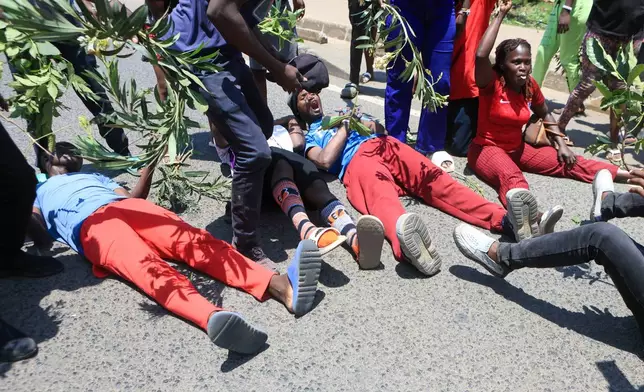 People react in the Kibera neighborhood of Nairobi, Kenya, to the death of Kenya former prime minister Raila Odinga Wednesday, Oct. 15, 2025. Odinga died of a heart attack in Indiaat the age of 80. (AP Photo/Andrew Kasuku)