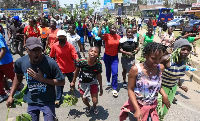 People react in the Kibera neighborhood of Nairobi, Kenya, to the death of Kenya former prime minister Raila Odinga Wednesday, Oct. 15, 2025. Odinga died of a heart attack in Indiaat the age of 80. (AP Photo/Andrew Kasuku)