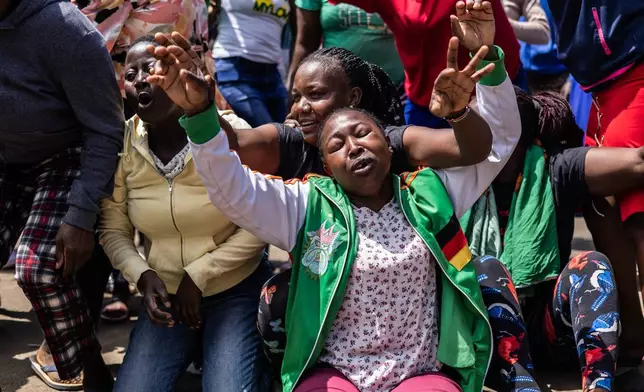 People react in the Kibera neighborhood of Nairobi, Kenya, to the death of Kenya former prime minister Raila Odinga Wednesday, Oct. 15, 2025. Odinga died of a heart attack in Indiaat the age of 80. (AP Photo/Samson Otieno)