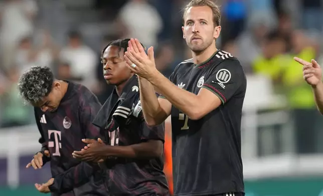 Bayern's Harry Kane, right, with teammates applaud their fans after the Champions League opening phase soccer match between Pafos FC and FC Bayern Munich at Alphamega stadium in Limassol, Cyprus, Tuesday, Sept. 30, 2025. (AP Photo/Petros Karadjias)
