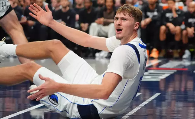 Dallas Mavericks forward Cooper Flagg reacts to a no-foul call during the second half of an NBA basketball game against the San Antonio Spurs in Dallas, Wednesday, Oct. 22, 2025. (AP Photo/LM Otero)