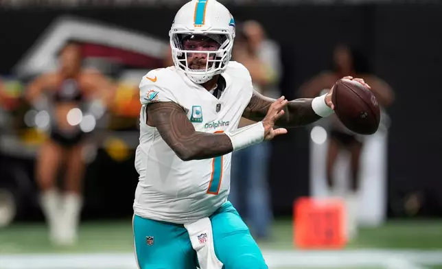 Miami Dolphins quarterback Tua Tagovailoa (1) looks to pass during the first half of an NFL football game against the Atlanta Falcons, Sunday, Oct. 26, 2025, in Atlanta. (AP Photo/Mike Stewart)