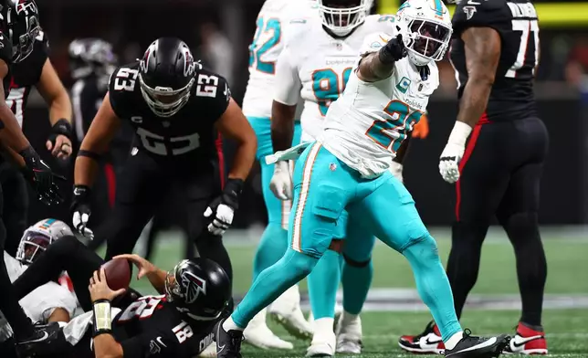 Miami Dolphins linebacker Jordyn Brooks (20) reacts after sacking Atlanta Falcons quarterback Kirk Cousins (18) during the first half of an NFL football game, Sunday, Oct. 26, 2025, in Atlanta. (AP Photo/Colin Hubbard)