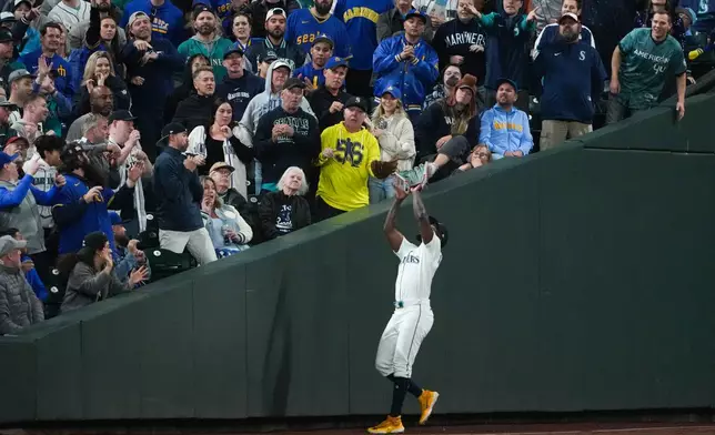 Seattle Mariners left fielder Randy Arozarena catches a fly ball hit by Detroit Tigers left fielder Riley Greene to take it to the bottom of the 15th inning in Game 5 of baseball's American League Division Series Friday, Oct. 10, 2025, in Seattle. (AP Photo/Lindsey Wasson)
