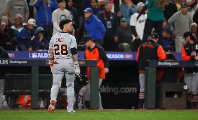 Detroit Tigers center fielder Javier Báez (28) walks to the dugout after popping out to end the top of the 14th inning in Game 5 of baseball's American League Division Series against the Seattle Mariners, Friday, Oct. 10, 2025, in Seattle. (AP Photo/Lindsey Wasson)