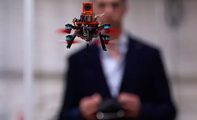 Colin Balfour, a sophomore studying robotics engineering, flies a small drone at a laboratory at the Worcester Polytechnic Institute, Monday, Oct. 20, 2025, in Worcester, Mass. (AP Photo/Charles Krupa)