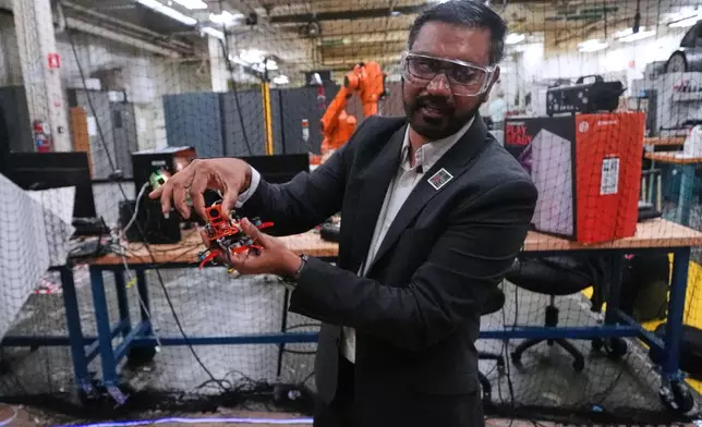 Nitan Sanket, assistant professor of robotics engineering, describes the components on a tiny drone at his lab at Worcester Polytechnic Institute, Monday, Oct. 20, 2025, in Worcester, Mass. (AP Photo/Charles Krupa)