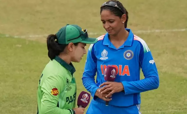 India's captain Harmanpreet Kaur, right, and Pakistan's captain Fatima Sana look on before the ICC Women's Cricket World Cup match between India and Pakistan at Premadasa Stadium in Colombo, Sri Lanka, Sunday, Oct, 5, 2025. (AP Photo/Eranga Jayawardena)