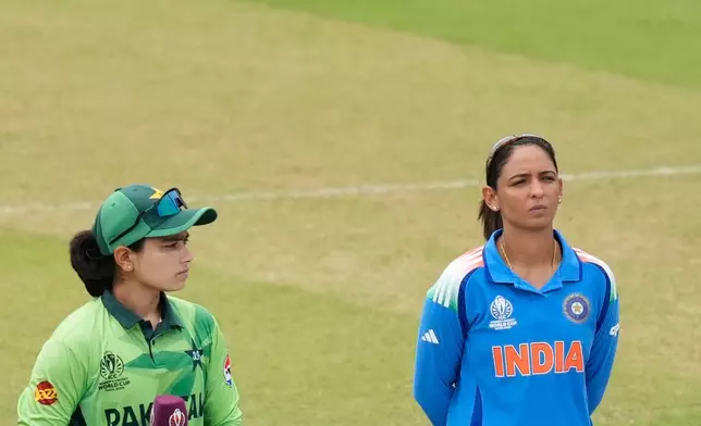 India's captain Harmanpreet Kaur, right, and Pakistan's captain Fatima Sana look on before the ICC Women's Cricket World Cup match between India and Pakistan at Premadasa Stadium in Colombo, Sri Lanka, Sunday, Oct, 5, 2025. (AP Photo/Eranga Jayawardena)