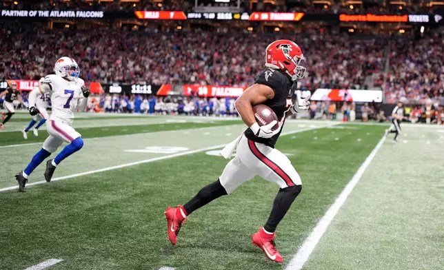 Atlanta Falcons running back Bijan Robinson (7) runs for a touchdown during the first half of an NFL football game against the Buffalo Bills, Monday, Oct. 13, 2025, in Atlanta. (AP Photo/Mike Stewart)