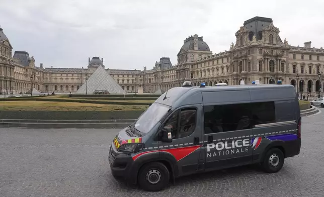 A police van patrols in the courtyard of the closed Louvre museum after a robbery Sunday, Oct. 19, 2025 in Paris. (AP Photo/Thibault Camus)