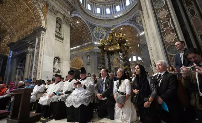 Faithful pray as Cardinal Raymond Leo Burke celebrates an old Latin Mass for pilgrims in St. Peter's Basilica, at the Vatican, Saturday, Oct. 25, 2025. (AP Photo/Alessandra Tarantino)