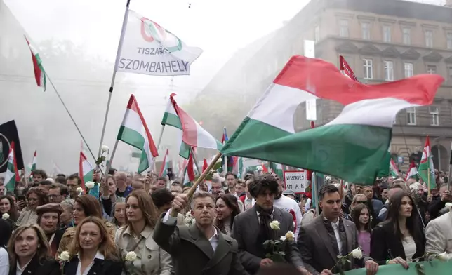 The leader of the Hungarian opposition TISZA party, Peter Magyar, foreground and center, rallies during a demonstration marking the 69th anniversary of the outbreak of Hungary's 1956 revolution against communist rule and the Soviet Union, in Budapest, Hungary, Thursday, Oct. 23, 2025. (AP Photo/Rudolf Karancsi)
