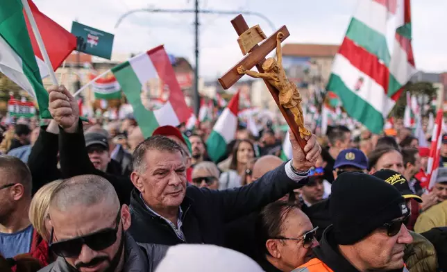 Pro-government demonstrators march during celebrations marking the 69th anniversary of the outbreak of Hungary's 1956 revolution against communist rule and the Soviet Union, in Budapest, Hungary, Thursday, Oct. 23, 2025. (AP Photo/Rudolf Karancsi)
