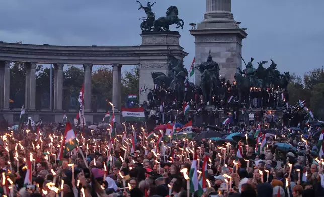 Demonstrators take part in a rally organized by the opposition TISZA party during celebrations marking the 69th anniversary of the outbreak of Hungary's 1956 revolution against communist rule and the Soviet Union, in Budapest, Hungary, Thursday, Oct. 23, 2025. (AP Photo/Rudolf Karancsi)