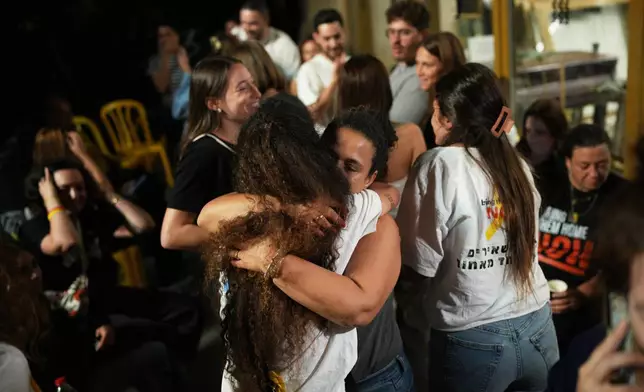 Relatives and supporters of Israeli hostages held by Hamas in the Gaza Strip celebrate after the announcement that Israel and Hamas have agreed to the first phase of a peace plan, as they gather at a plaza known as the hostages square in Tel Aviv, Israel, Thursday, Oct. 9, 2025. (AP Photo/Emilio Morenatti)