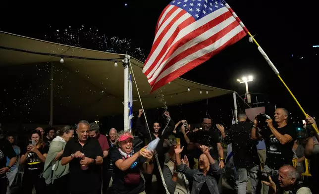 Relatives and supporters of Israeli hostages held by Hamas in the Gaza Strip celebrate after the announcement that Israel and Hamas have agreed to the first phase of a peace plan, as they gather at a plaza known as the hostages square in Tel Aviv, Israel, Thursday, Oct. 9, 2025. (AP Photo/Ohad Zwigenberg)