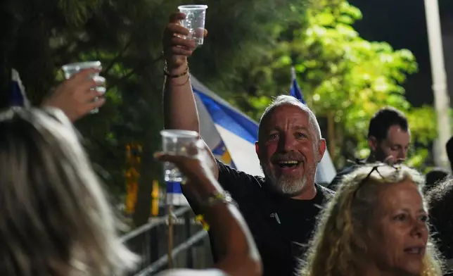 Relatives and supporters of Israeli hostages held by Hamas in the Gaza Strip celebrate after the announcement that Israel and Hamas have agreed to the first phase of a peace plan, as they gather at a plaza known as the hostages square in Tel Aviv, Israel, Thursday, Oct. 9, 2025. (AP Photo/Emilio Morenatti)