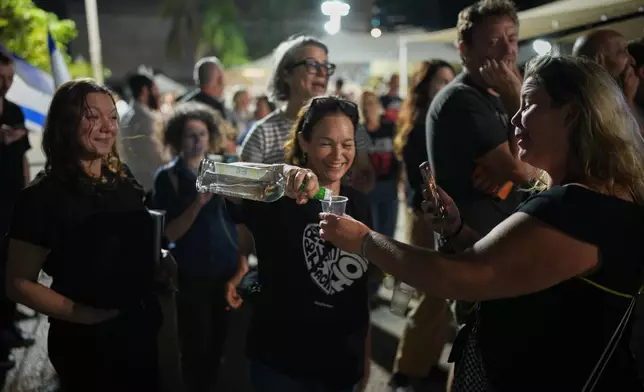 Relatives and supporters of Israeli hostages held by Hamas in the Gaza Strip celebrate after the announcement that Israel and Hamas have agreed to the first phase of a peace plan, as they gather at a plaza known as the hostages square in Tel Aviv, Israel, Thursday, Oct. 9, 2025. (AP Photo/Emilio Morenatti)