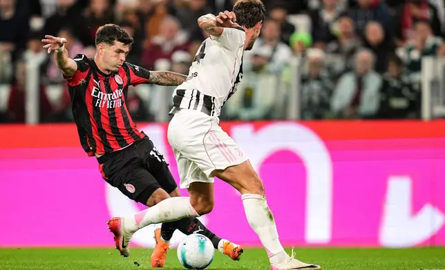 AC Milan's Christian Pulisic, left, and Juventus' Daniele Rugani in action during the Serie A soccer match between Juventus and AC Milan at the Allianz Stadium in Turin, Italy, Sunday Oct. 5, 2025. (Marco Alpozzi/LaPresse via AP)