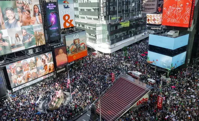 Thousands of protesters fill Times Square during a "No Kings" protest Saturday, Oct. 18, 2025, in New York. (AP Photo/Olga Fedorova)