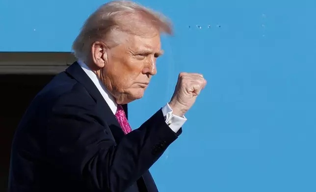 President Donald Trump gestures from the stairs of Air Force One as he boards upon his arrival at Joint Base Andrews, Md., Friday, Oct. 17, 2025. (AP Photo/Luis M. Alvarez)