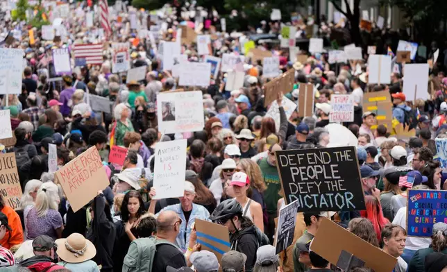 FILE - Demonstrators take part in the "No Kings" protest, June 14, 2025, in Portland, Ore. (AP Photo/Jenny Kane, File)