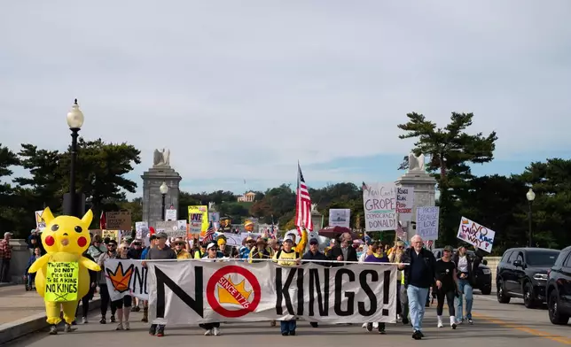 Crowds cross the memorial bridge as part of a No Kings protest, Saturday, Oct. 18, 2025, in Washington. (AP Photo/Allison Robbert)