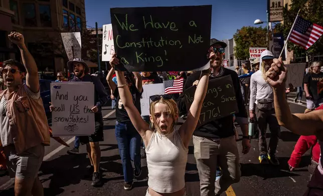 Daniella Diener participates with other protesters in the "No Kings" rally and march in downtown Albuquerque, N.M., on Saturday, Oct. 18, 2025. (Chancey Bush/The Albuquerque Journal via AP)