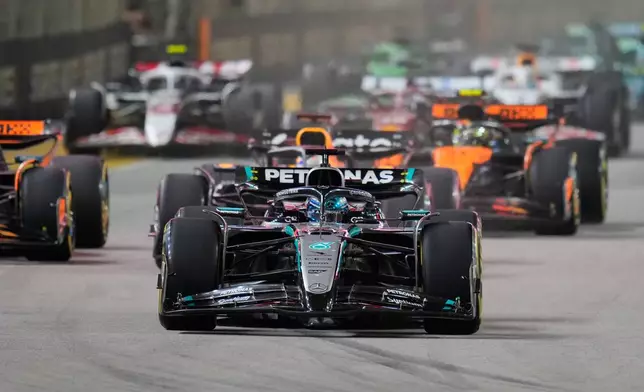 Mercedes driver George Russell of Britain leads the field after the start during the Singapore Formula One Grand Prix at the Marina Bay Street Circuit in Singapore, Sunday, Oct. 5, 2025. (AP Photo/Vincent Thian)