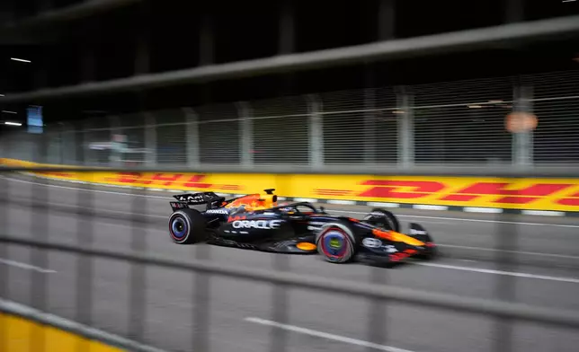 Red Bull driver Max Verstappen of the Netherlands steers his car during the Singapore Formula One Grand Prix at the Marina Bay Street Circuit in Singapore, Sunday, Oct. 5, 2025. (AP Photo/Vincent Thian)