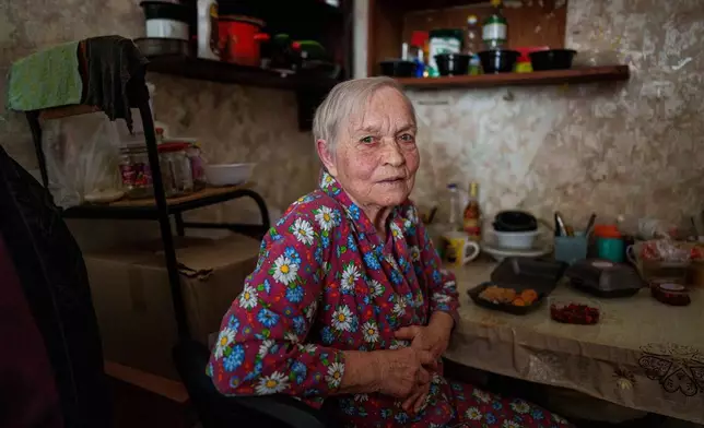 Valentina Khusak, 86, sits in her room at a hostel for displaced persons in Dnipro, Ukraine, Wednesday, Oct. 8, 2025. (AP Photo/Evgeniy Maloletka)
