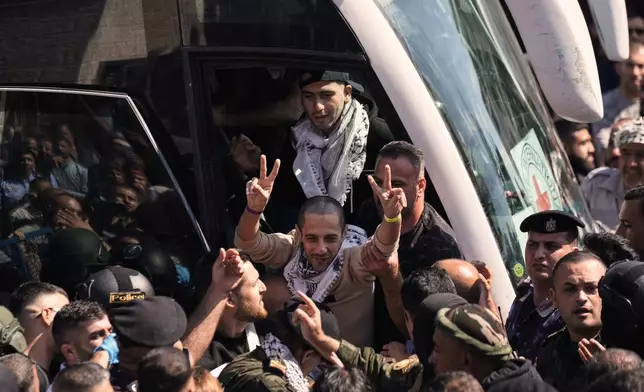 A Palestinian prisoner makes the victory sign after being released from an Israeli prison as part of a ceasefire deal between Israel and Hamas, upon his arrival in the West Bank city of Ramallah, Monday, Oct. 13, 2025. (AP Photo/Majdi Mohammed)